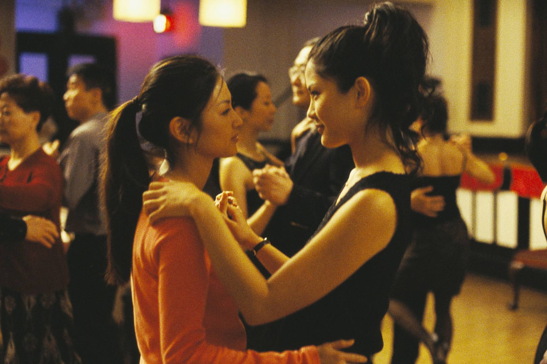 Michelle Krusiec and Lynn Chen slow dance, staring into each others' eyes.